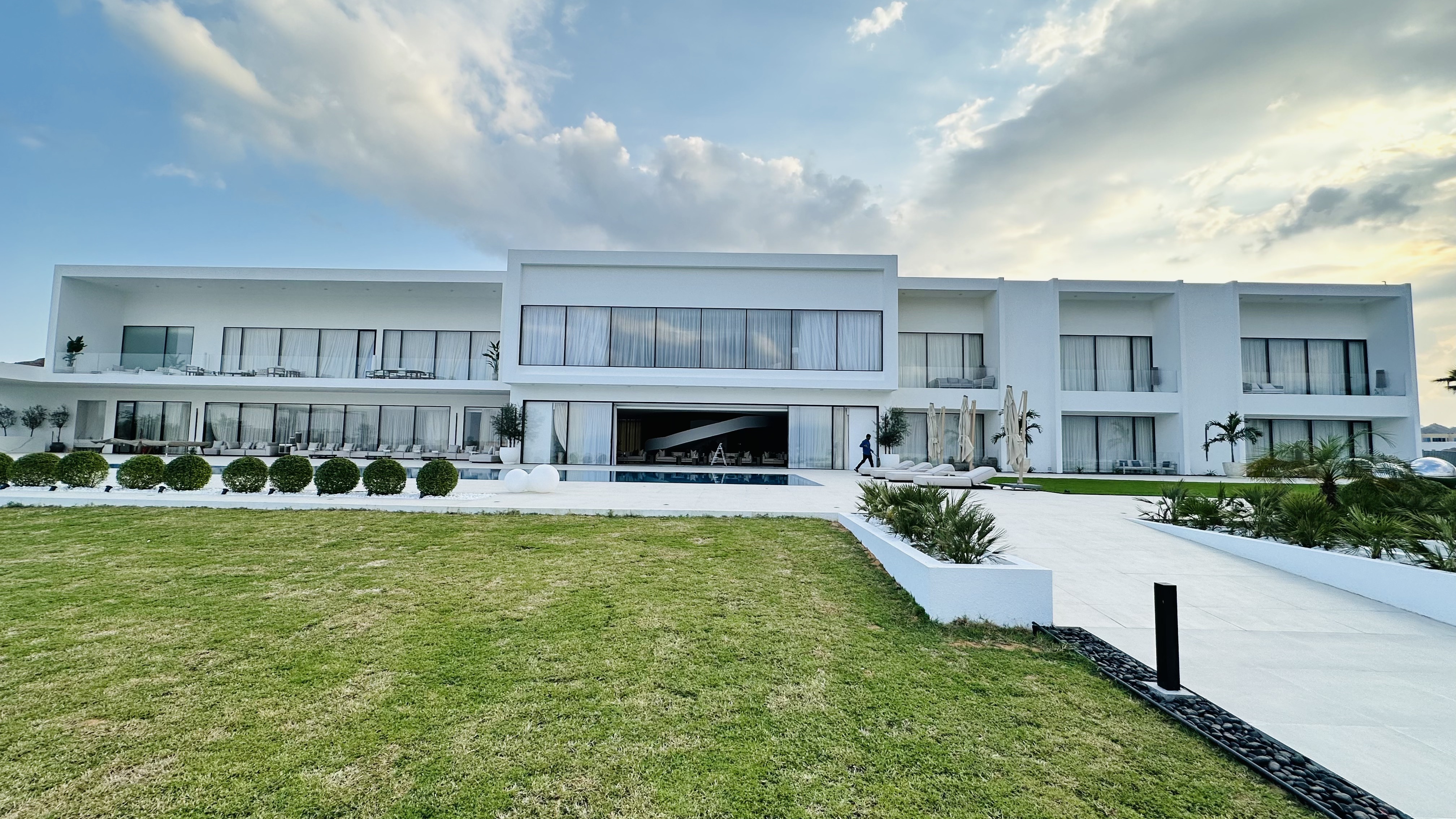 Wide waterfront lawn and villa