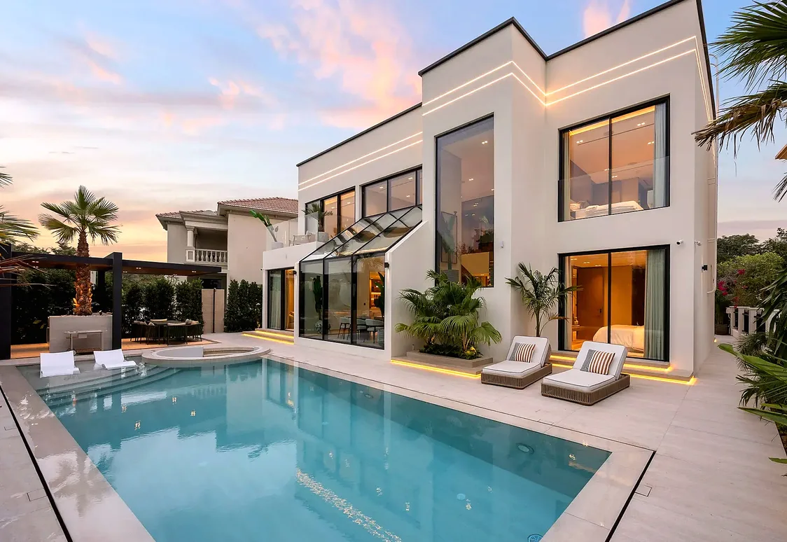 Jumeirah Islands pool facade with large VetroMax glazed openings at evening light