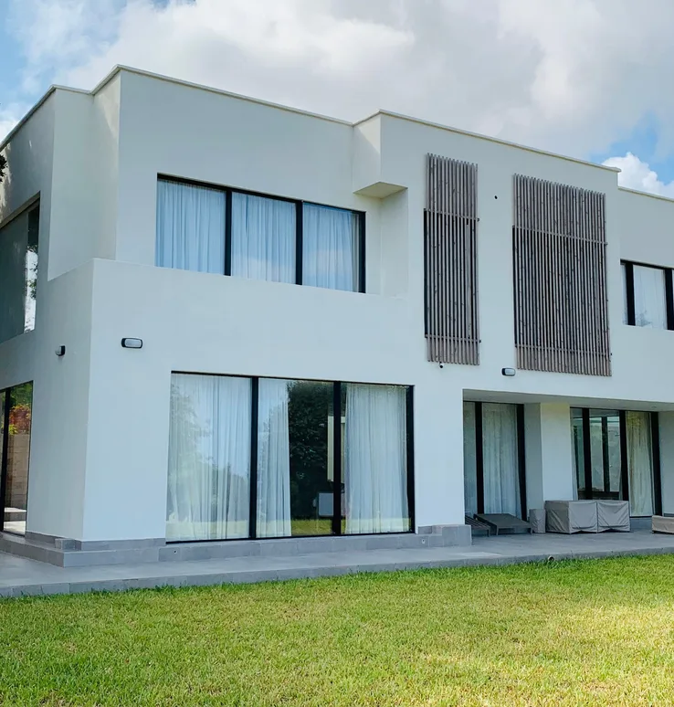 Vipingo private villa front elevation with large glazed openings and lawn