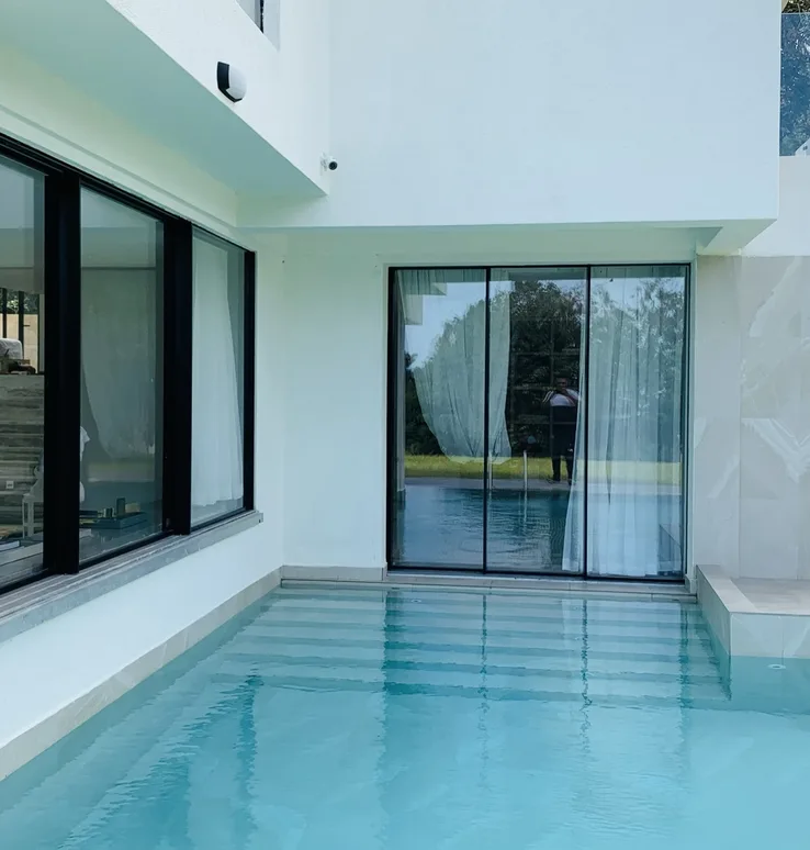 Vipingo villa pool corner with sliding glass opening beside the water